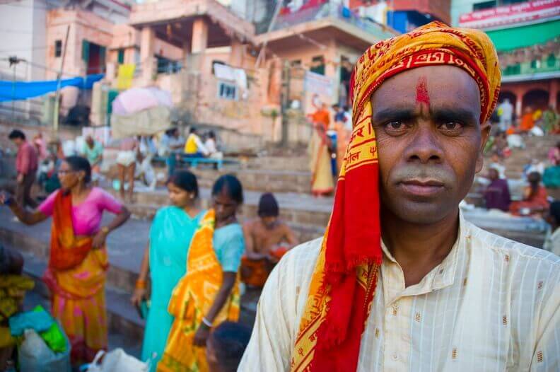 India- Local man in Varanasi at the ghats, where pilgrims gather for rituals by the sacred Ganges River. 