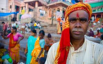 India- Local man in Varanasi at the ghats, where pilgrims gather for rituals by the sacred Ganges River. 
