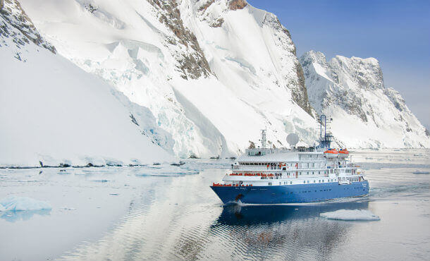 The Sea Spirit cruises through Antarctica's icy water past towering glaciers. 