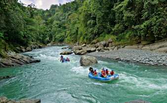 White-water rafting on the Pacuare River through lush rainforest in Costa Rica. 