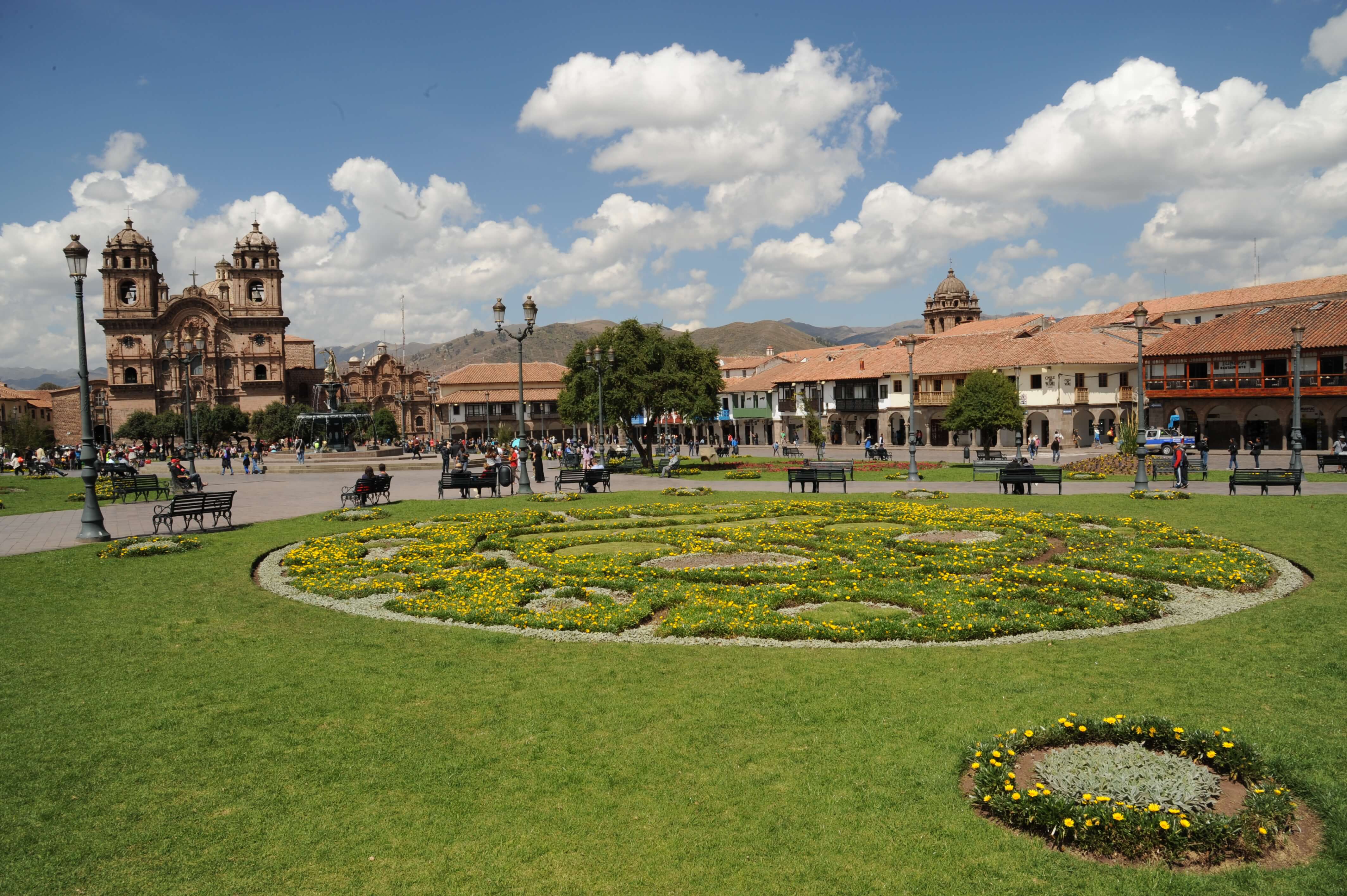 Cusco's Plaza de Armas glows under Andean skies, with vibrant gardens and colonial architecture all around. 
