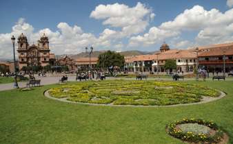 Cusco's Plaza de Armas glows under Andean skies, with vibrant gardens and colonial architecture all around. 