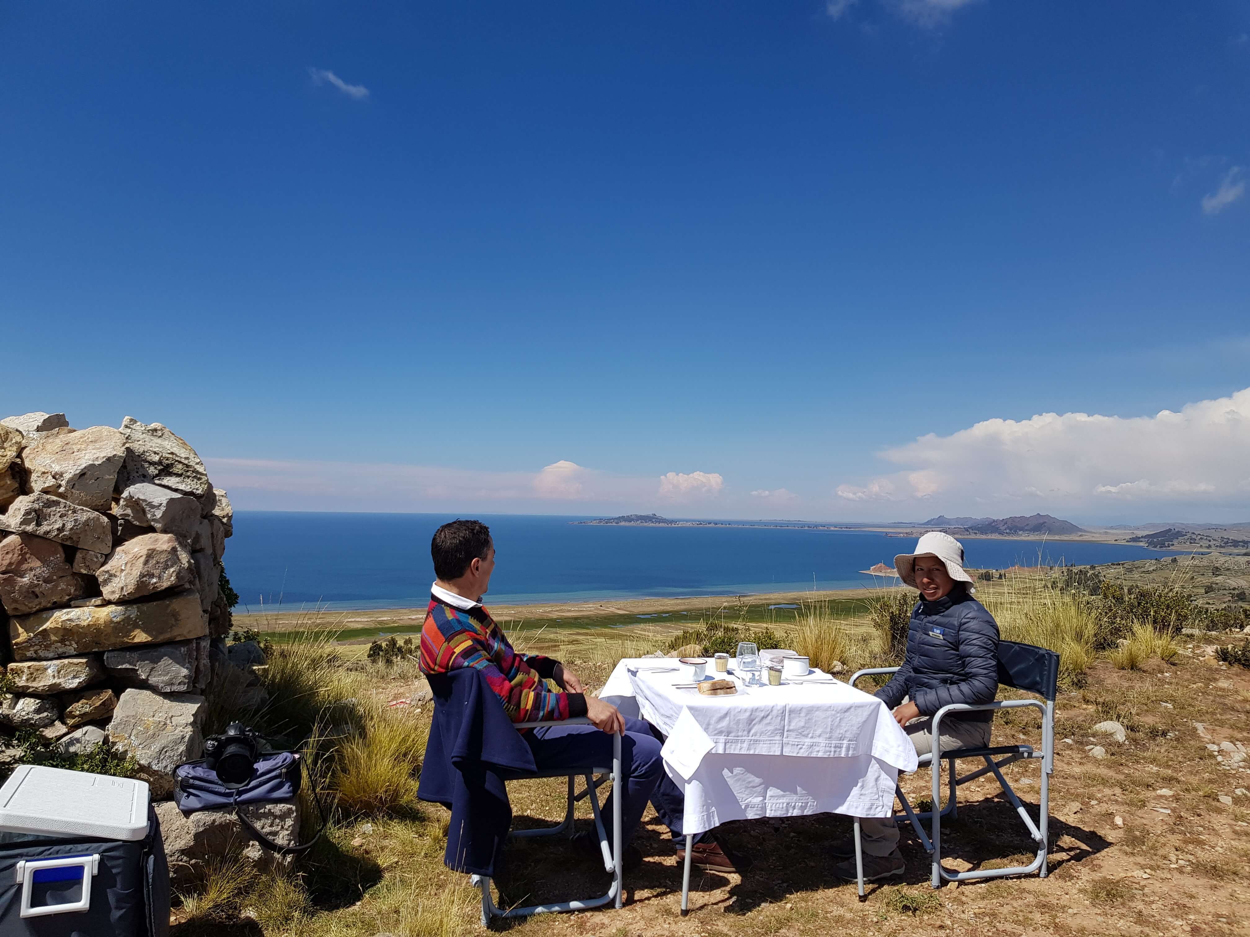 Private picnic setup with panoramic views of Lake Titicaca in the Peruvian highlands. 