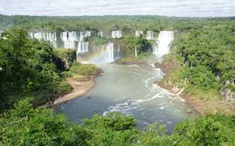 Iguassu Falls thunders through Brazil's rainforest in a sweeping panoramic view. 