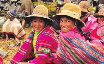 Smiling Peruvian girls in colourful traditional clothing, Sacred Valley Cultural Heritage. 