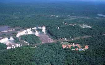 Aerial view of Brazil's Iguassu Falls and rainforest lodges nestled nearby. 