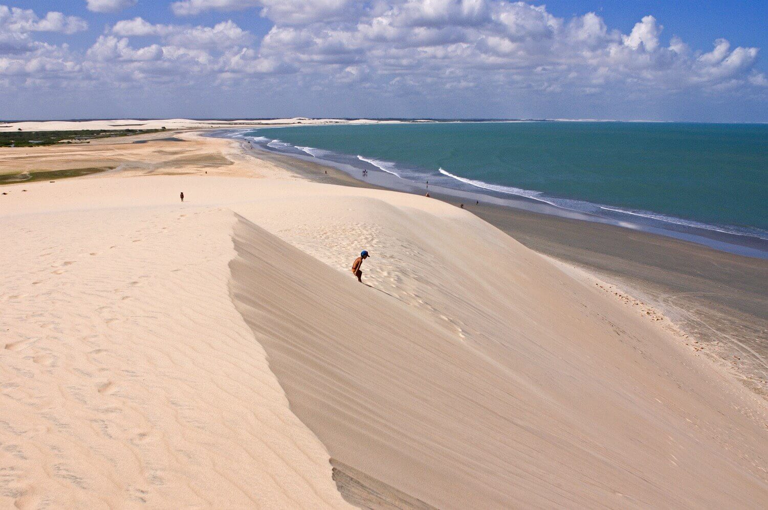 Vast sand dunes at Duna do Por do Sol in Jericoacoara, Ceara, Brazil, with ocean views and ridge.  