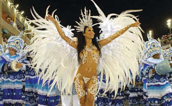 Samba queen in feathered costume leading Rocinha school at Rio Carnival parade, Brazil. 