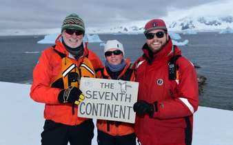 Expedition guests celebrate reaching Antarctica, the world's seventh continent. 